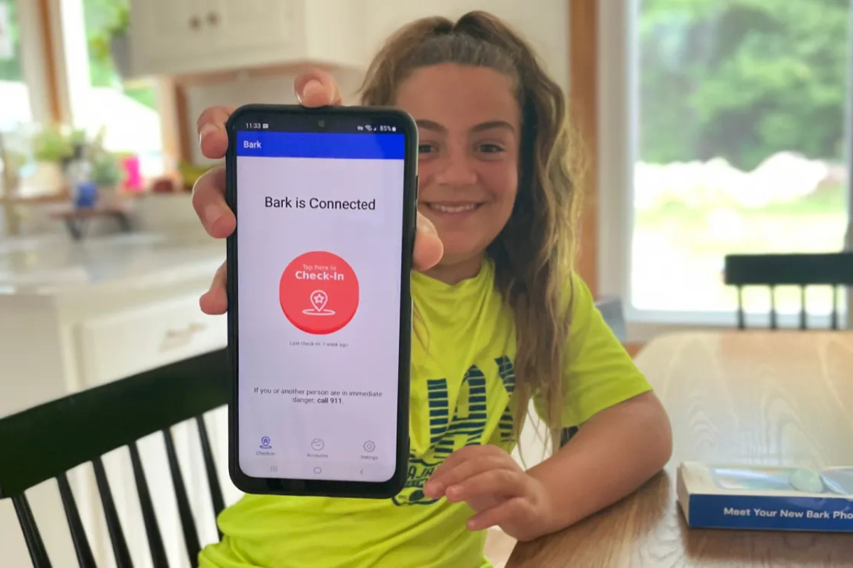 Mom and daughter using phone together